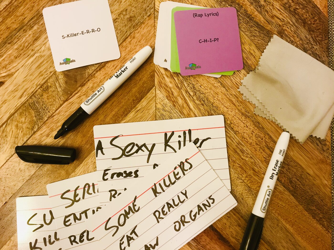 AcroMania dry-erase answer cards filled in with funny answers